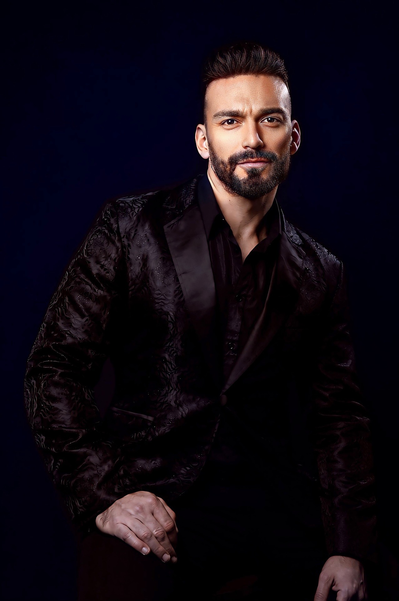 Gianluca Margheri in an elegant black jacket on a dark studio background