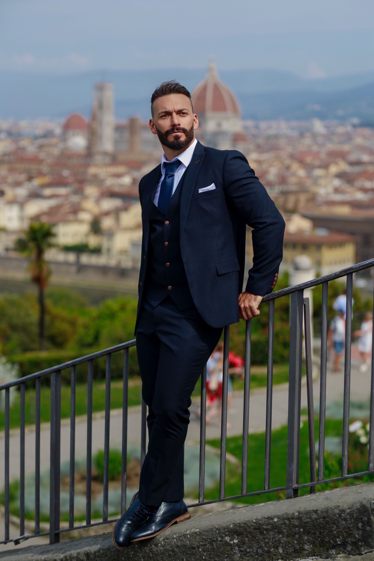 Gianluca Margheri in a navy suit overlooking Florence